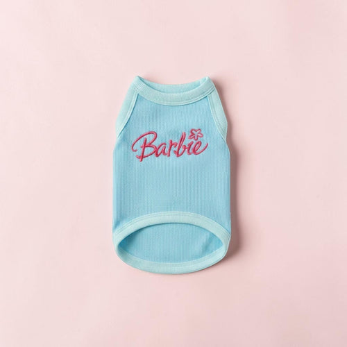 The Spoiled Pet Club light blue ribbed dog tank top with pink Barbie embroidery on a soft pink background.