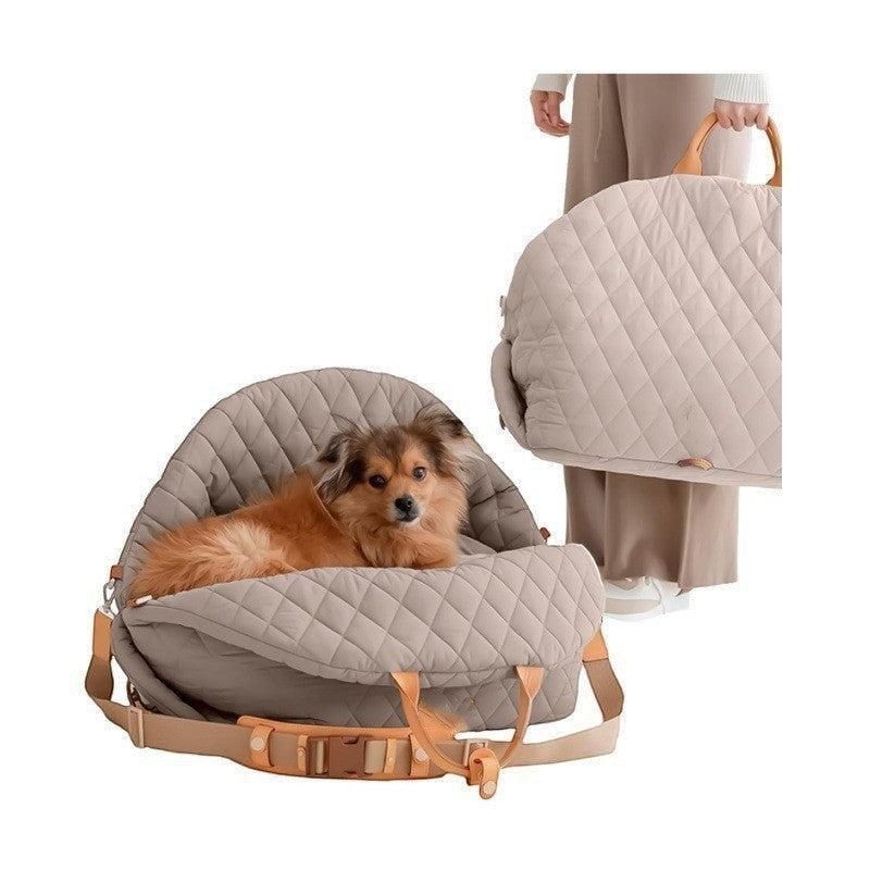 The Spoiled Pet Club beige quilted nylon pet carrier bag with a small dog resting inside and a hand-carry strap.