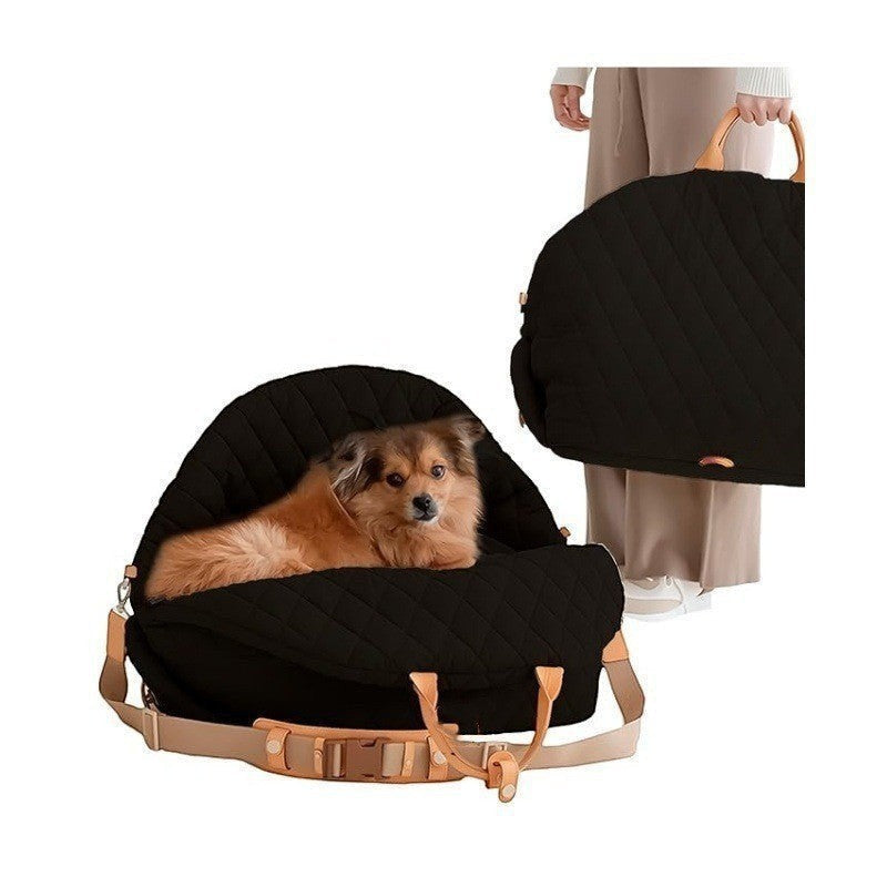The Spoiled Pet Club black quilted nylon pet carrier bag with tan leather handles and adjustable shoulder strap
