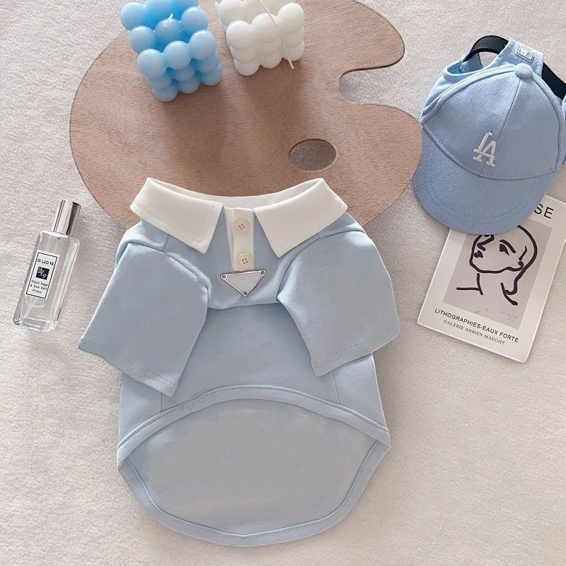 The Spoiled Pet Club light blue cotton dog polo shirt with white collar and button placket on a flat lay background.
