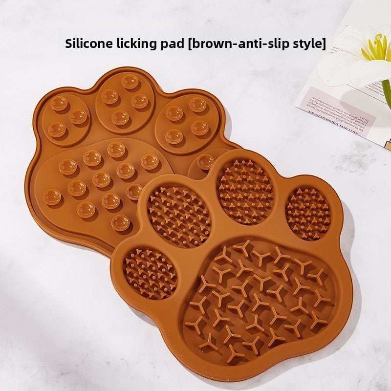 The Spoiled Pet Club brown silicone paw-shaped lick mat with suction cups for slow feeding and pet enrichment