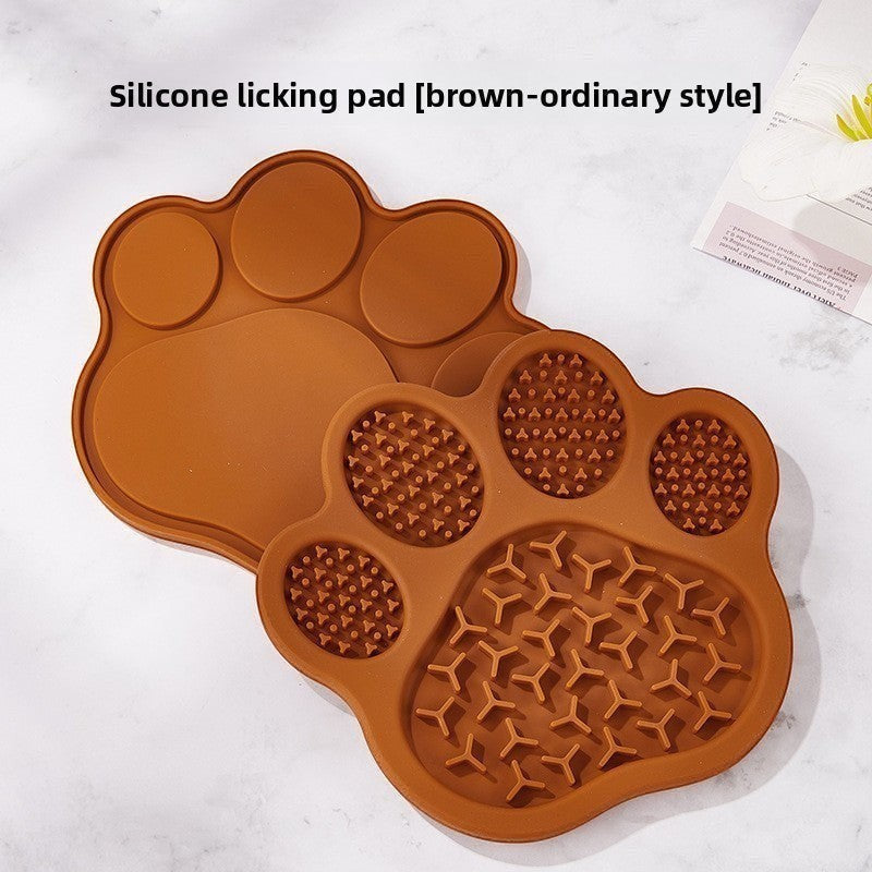 The Spoiled Pet Club brown silicone paw-shaped lick mat for slow feeding with textured surface