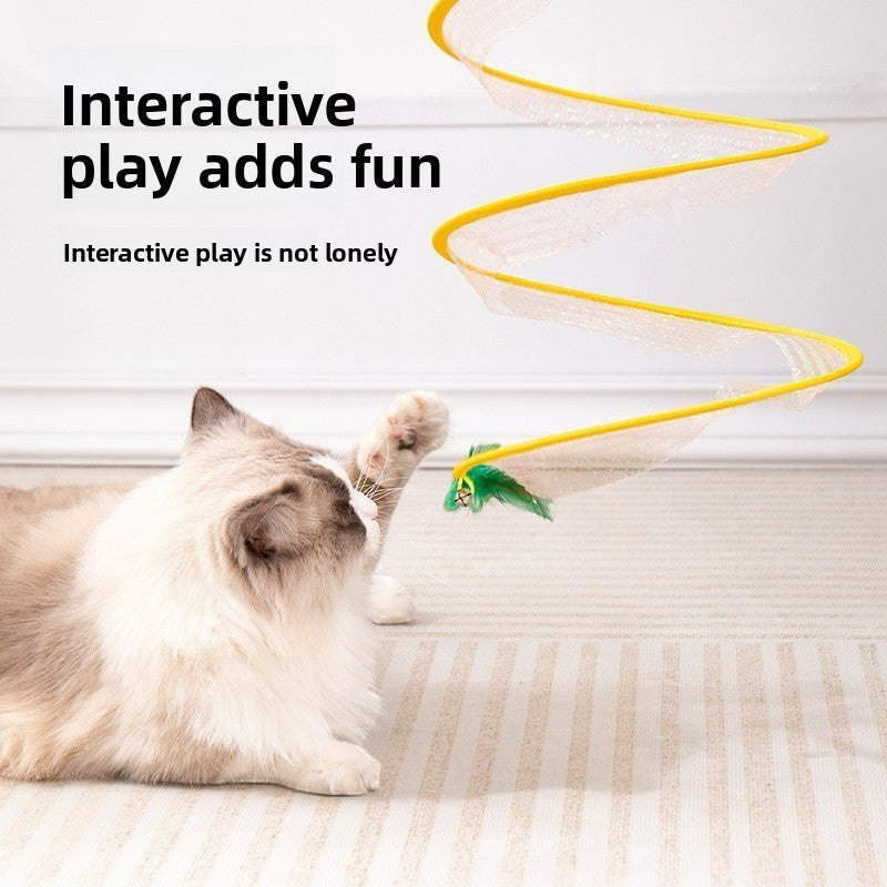 The Spoiled Pet Club cat playing with a yellow interactive teaser stick toy featuring a green feather attachment