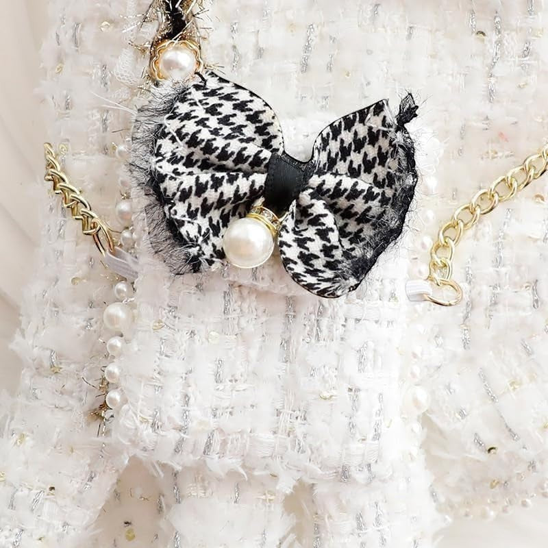 The Spoiled Pet Club Dahlia Darling Tweed Dress features a black and white houndstooth bow with pearl accent and gold chain detail.