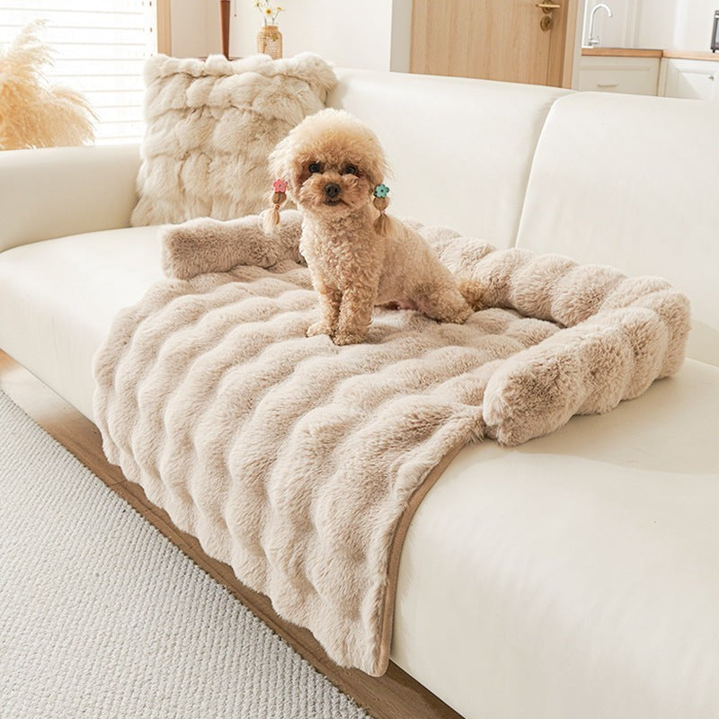 The Spoiled Pet Club Heavenly Paw Couch Nest, a plush, light brown dog bed with raised sides and a wavy texture, featuring a small poodle with colorful hair clips.