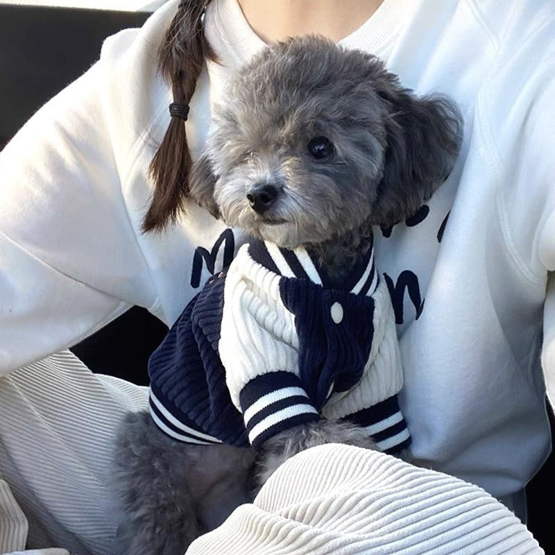 The Spoiled Pet Club navy and white striped knit dog jacket with contrasting sleeves and button closure.