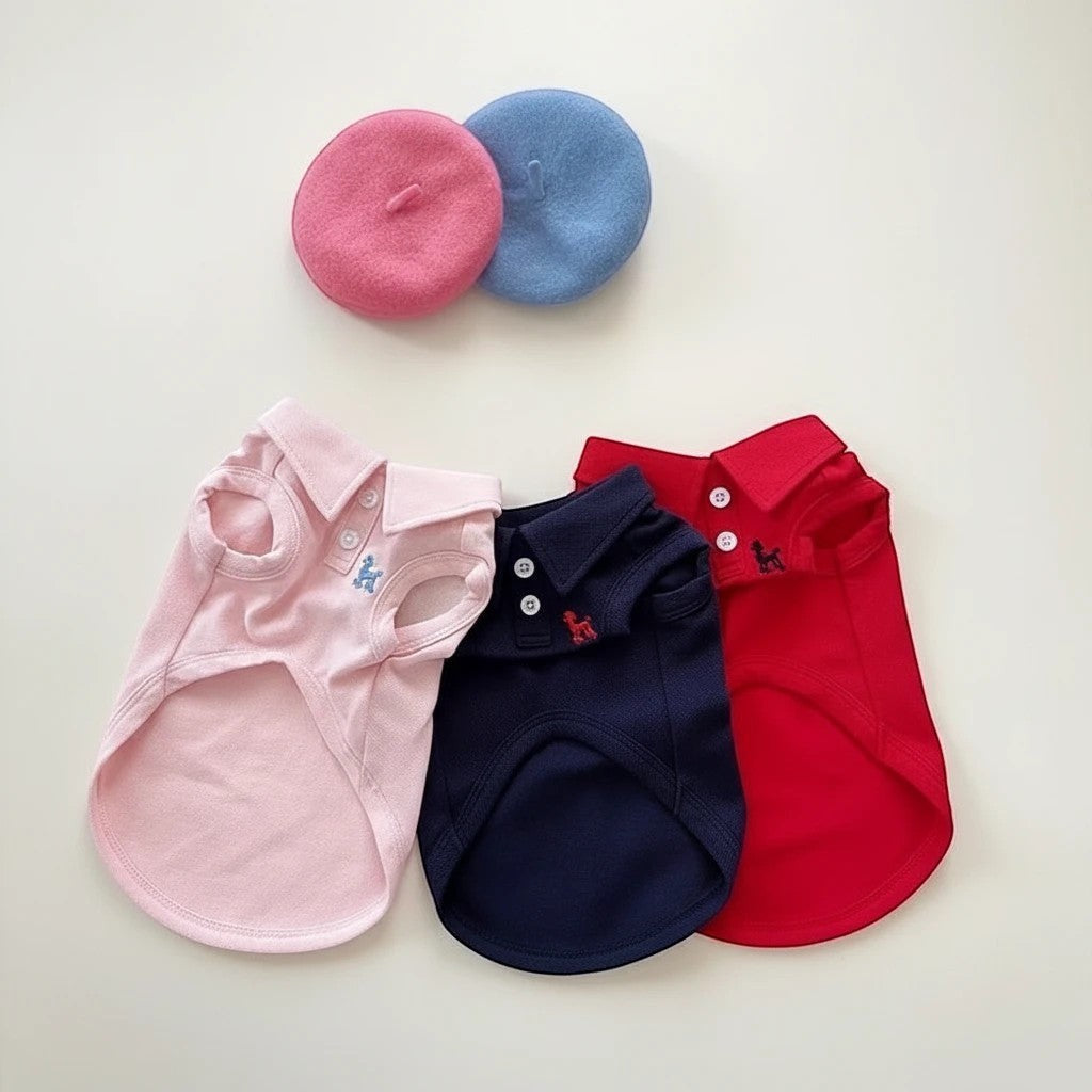 The Spoiled Pet Club pink, navy, and red polyester dog vests with embroidered dog detail and button collar.
