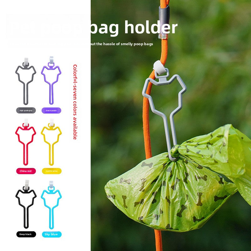 The Spoiled Pet Club dog waste bag holder in grey, attached to an orange leash with a green bag of waste.