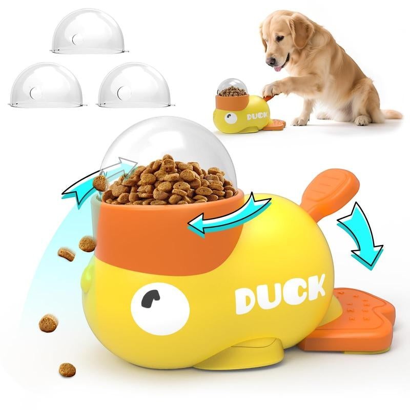 The Spoiled Pet Club Treat Me Duck treat dispenser is yellow and orange, with a clear dome top filled with kibble. A Golden Retriever nudges the dispenser.