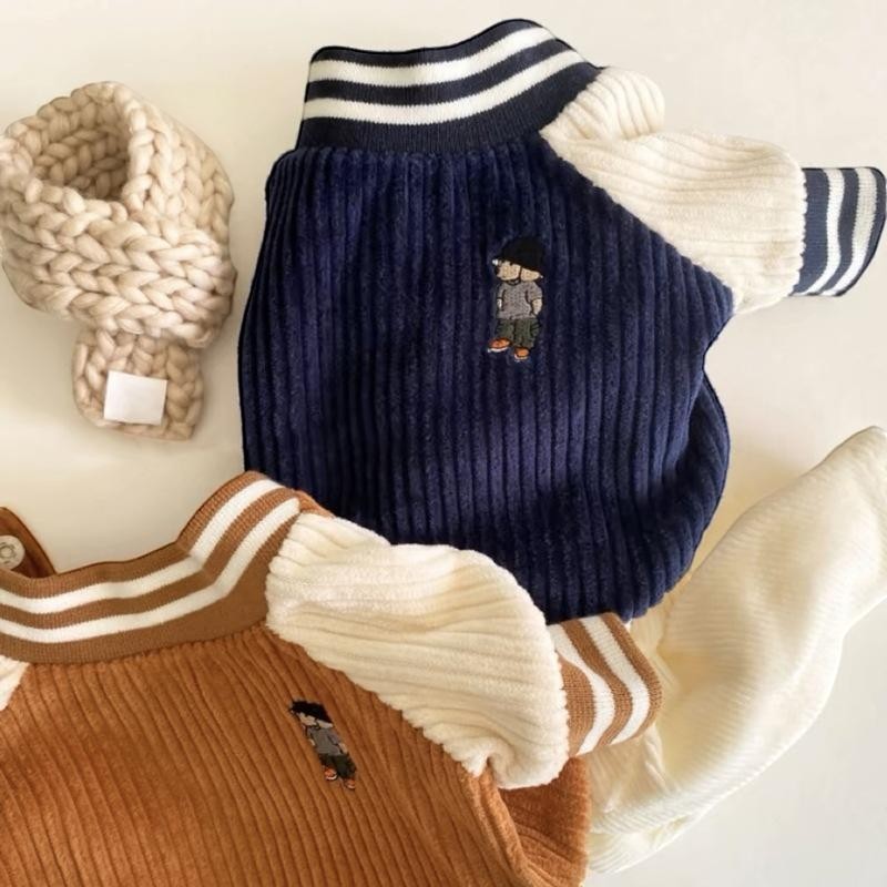 The Spoiled Pet Club navy and tan corduroy knit pullovers with contrasting cream sleeves and embroidered figures. Ribbed texture.