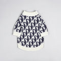The Spoiled Pet Club Highlands Sweater featuring a white and navy blue designer-inspired monogram knit pattern.