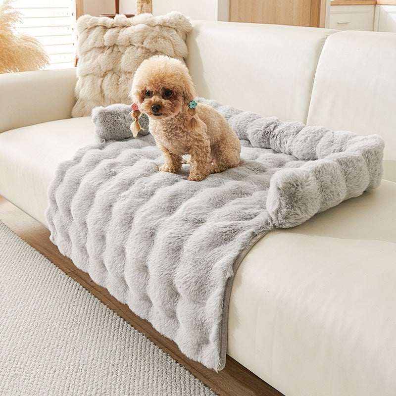 The Spoiled Pet Club light gray plush couch nest with a small dog sitting on it.