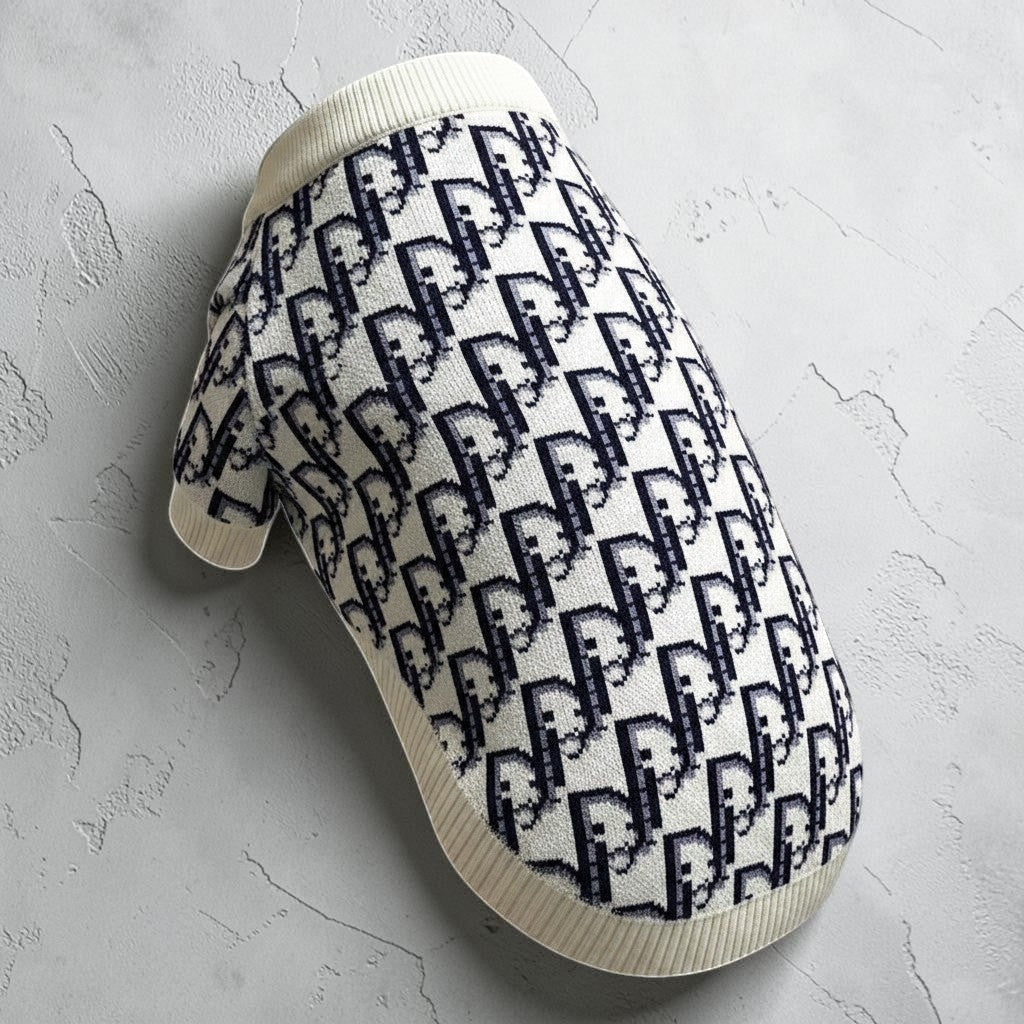 The Spoiled Pet Club dog sweater in white and black with a designer-inspired monogram pattern and ribbed trim.
