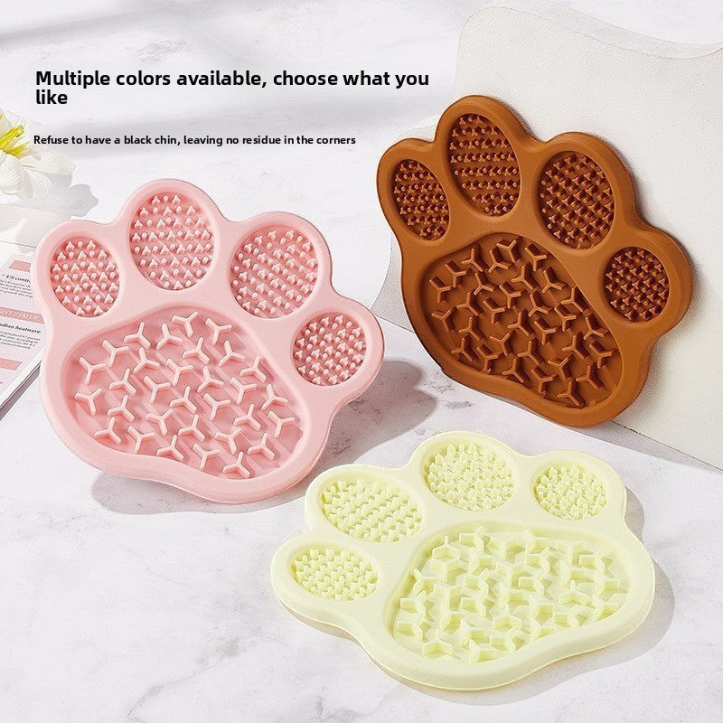The Spoiled Pet Club paw-shaped silicone lick mats in pink, brown, and beige for slow feeding and pet enrichment