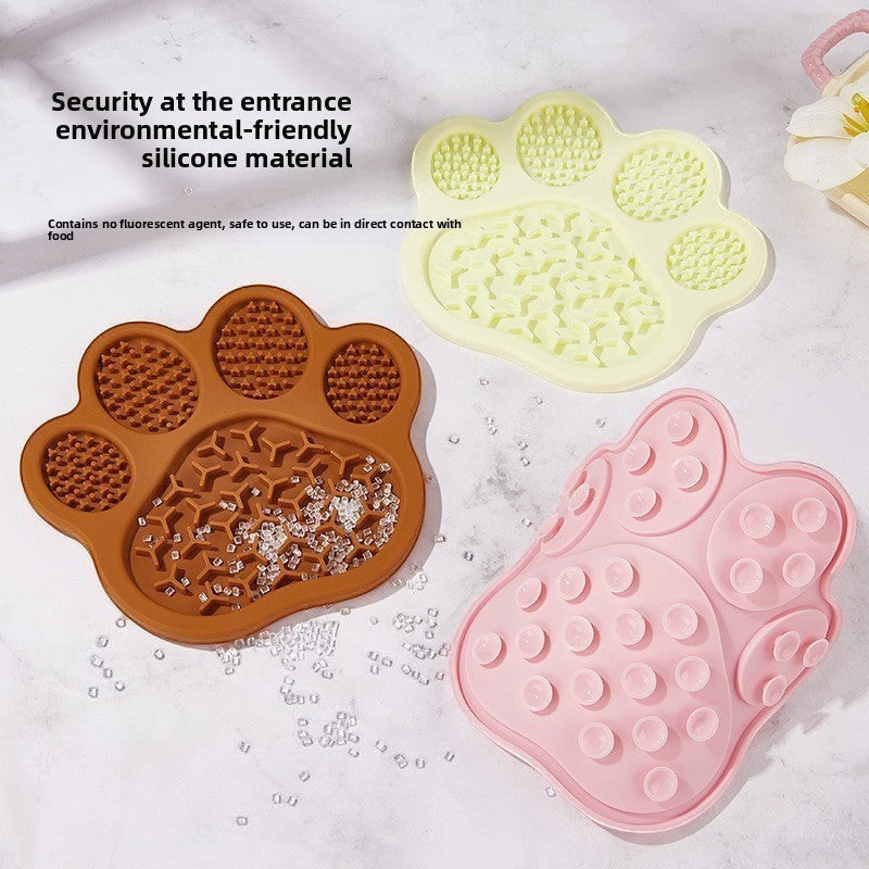 The Spoiled Pet Club paw-shaped silicone lick mats in brown, beige, and pink with suction cups for slow feeding.