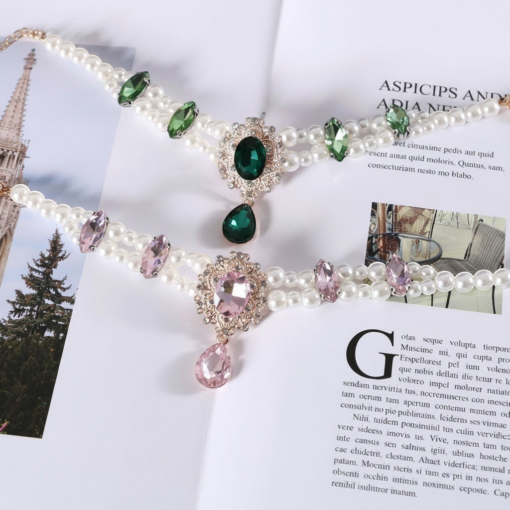 The Spoiled Pet Club Heiress pet collars featuring white pearls, crystal accents, and green or pink teardrop pendants.
