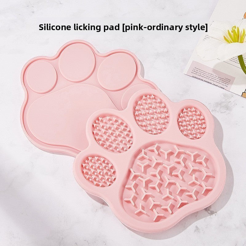 The Spoiled Pet Club pink silicone paw-shaped lick mat for slow feeding and pet enrichment