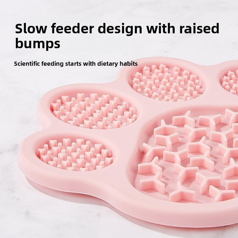 The Spoiled Pet Club pink silicone paw-shaped slow feeder lick mat with raised textured bumps for pet digestion