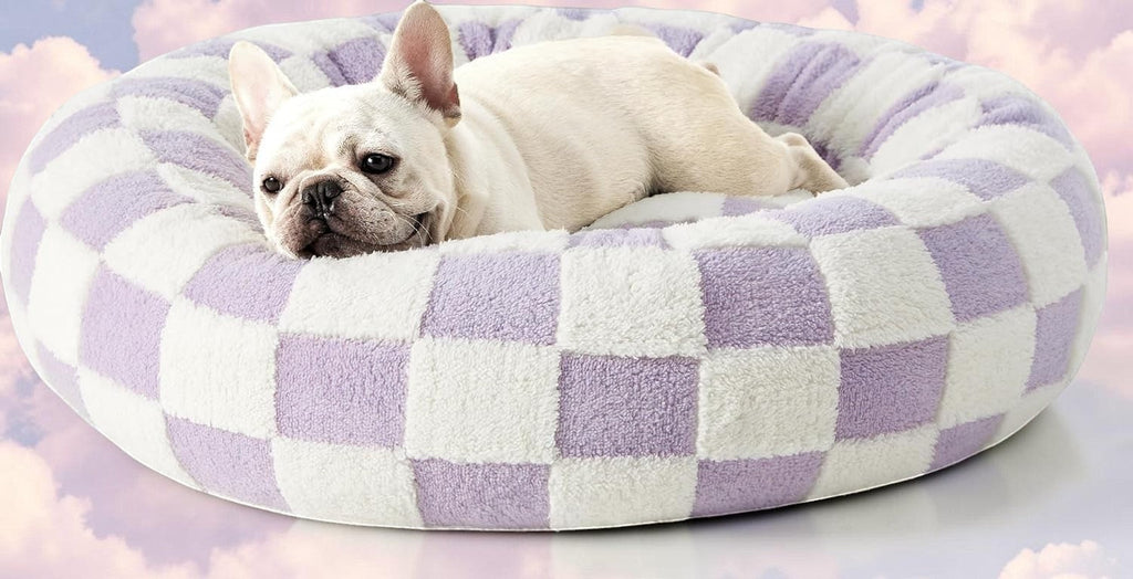 The Spoiled Pet Club round pet bed in purple and white plaid, featuring a cozy nest design for dogs or cats.