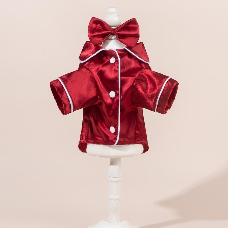 The Spoiled Pet Club red satin pajama shirt with white piping and a matching bow detail.