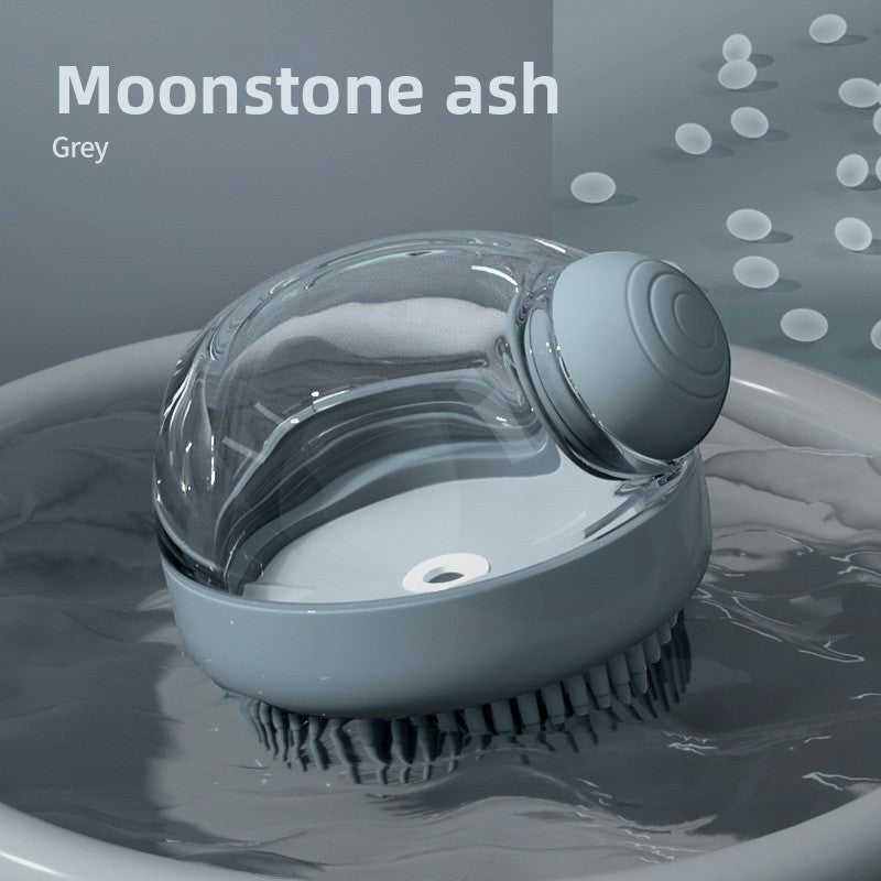 The Spoiled Pet Club Serene Suds Dispenser in grey, a silicone grooming brush with a built-in soap dispenser for pet baths.