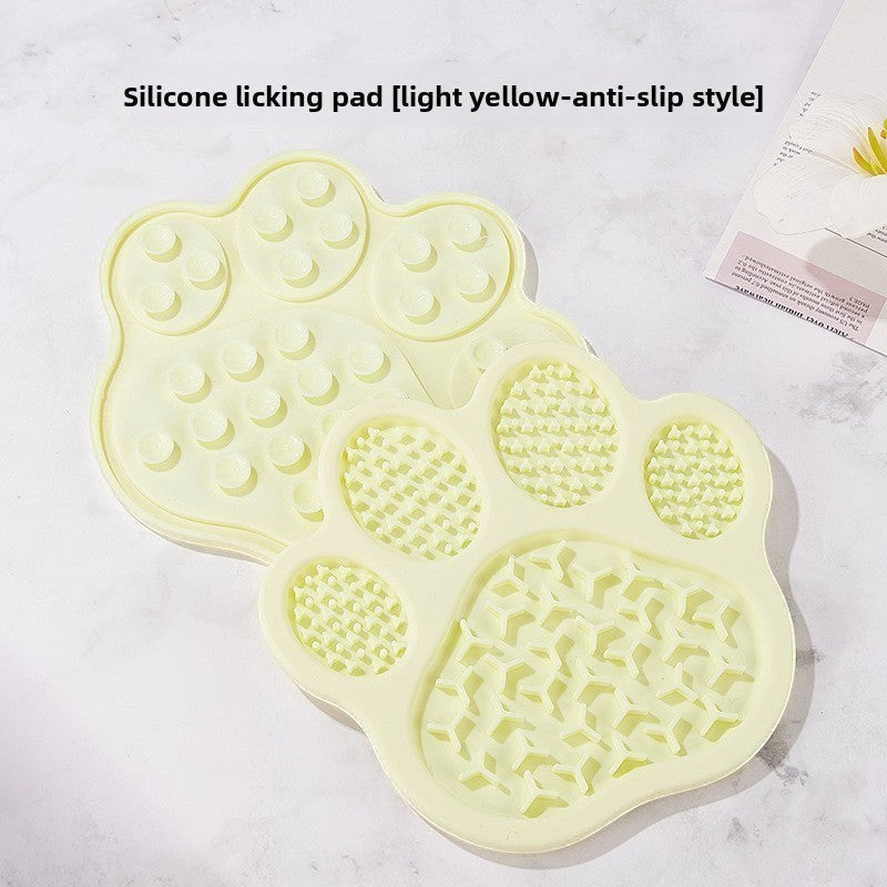 The Spoiled Pet Club light yellow paw-shaped silicone lick mat with anti-slip suction cups for slow feeding