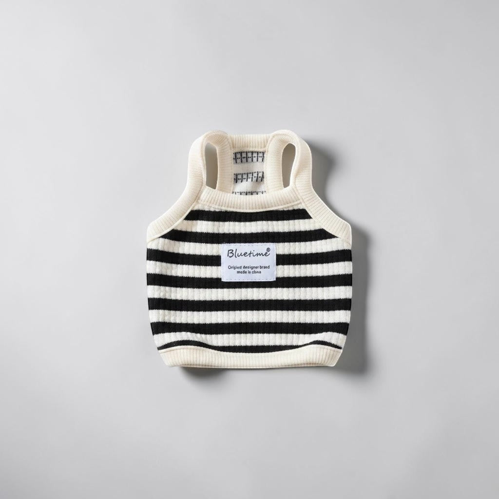 The Spoiled Pet Club black and white striped ribbed dog tank top with a designer label on a light grey background.